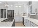 Modern kitchen with white cabinets, a center island, and stainless steel appliances at 225 Midenhall Way, Cary, NC 27513
