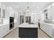 Spacious kitchen with a center island, white cabinets, and modern lighting at 225 Midenhall Way, Cary, NC 27513