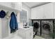 Functional laundry room with sink, cabinets, and modern washer and dryer units at 225 Midenhall Way, Cary, NC 27513