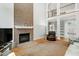Inviting living room features a brick fireplace and staircase to second level at 225 Midenhall Way, Cary, NC 27513