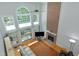 Bright living room with a fireplace, large windows and a leather sofa at 225 Midenhall Way, Cary, NC 27513