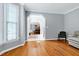 Cozy living room with hardwood floors and an arched doorway leading to the dining room at 225 Midenhall Way, Cary, NC 27513