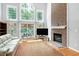 Spacious living room with hardwood floors, fireplace, large windows, and a comfortable seating area at 225 Midenhall Way, Cary, NC 27513