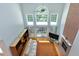 Open living room with fireplace, high ceilings, large windows, and patio door at 225 Midenhall Way, Cary, NC 27513