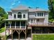Expansive home exterior with screened porch and wood deck overlooking the backyard at 225 Midenhall Way, Cary, NC 27513