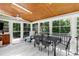 Bright sunroom featuring wood-paneled ceiling, skylights, large windows and an open design to a balcony at 225 Midenhall Way, Cary, NC 27513