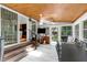 Bright sunroom featuring wood-paneled ceiling, skylights, tile floors, large windows and an open design to the home at 225 Midenhall Way, Cary, NC 27513