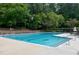 Outdoor community swimming pool with lounge seating, green surroundings, and marked lanes at 225 Midenhall Way, Cary, NC 27513