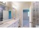 Bathroom with a double vanity and framed mirror, leading to the bedroom and glass-enclosed shower at 2299 Bay Minette Sta # 537, Apex, NC 27502