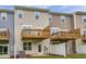 Exterior view of townhomes with private wooden decks and well-maintained lawn at 2299 Bay Minette Sta # 537, Apex, NC 27502