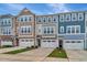Charming townhouse exteriors boast a mix of stone, siding, and contrasting trim at 2299 Bay Minette Sta # 537, Apex, NC 27502