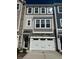 Well-maintained townhouse featuring a two-car garage and classic architectural details at 2299 Bay Minette Sta # 537, Apex, NC 27502