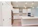 Stylish kitchen features stainless steel refrigerator, white cabinets, and quartz countertops at 2299 Bay Minette Sta # 537, Apex, NC 27502
