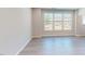 Well-lit living room with hardwood flooring and view of the outdoors through large window at 2299 Bay Minette Sta # 537, Apex, NC 27502