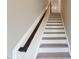 Clean and bright staircase features white risers and dark wood handrail at 2299 Bay Minette Sta # 537, Apex, NC 27502