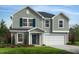 Charming two-story home with blue shutters and a well-manicured lawn showcasing curb appeal at 235 Norman Ave, Lillington, NC 27546