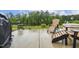 Relaxing back patio features outdoor furniture and a peaceful wooded backdrop at 2410 Kinglass Dr, Fuquay Varina, NC 27526