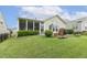 Backyard with a screened porch and patio seating, blending indoor and outdoor living at 2410 Kinglass Dr, Fuquay Varina, NC 27526
