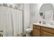 Bright bathroom features a vanity with wood cabinets, white countertop, and a round mirror at 2410 Kinglass Dr, Fuquay Varina, NC 27526