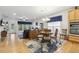 Open concept living and dining areas with hardwood floors, large windows, and modern decor at 2410 Kinglass Dr, Fuquay Varina, NC 27526