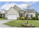 Inviting home exterior with well-kept lawn, charming landscaping and a two car garage at 2410 Kinglass Dr, Fuquay Varina, NC 27526