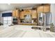 Close-up of kitchen island featuring modern sink, stainless-steel appliances, and light fixtures at 2410 Kinglass Dr, Fuquay Varina, NC 27526