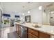 Spacious kitchen island with white countertops, stainless steel appliances, and wood floors at 2410 Kinglass Dr, Fuquay Varina, NC 27526