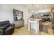 Open-concept kitchen and living area with a kitchen island and hardwood floors at 2410 Kinglass Dr, Fuquay Varina, NC 27526