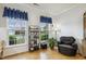 Comfortable living area with large windows, hardwood floors, and a cozy seating arrangement at 2410 Kinglass Dr, Fuquay Varina, NC 27526