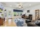 Inviting living room with hardwood floors, plush seating, a ceiling fan, and access to outdoor space at 2410 Kinglass Dr, Fuquay Varina, NC 27526