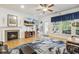 Cozy living room with hardwood floors, a fireplace, and natural light, creating a warm and inviting atmosphere at 2410 Kinglass Dr, Fuquay Varina, NC 27526