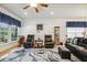 Comfortable living room with natural light, hardwood floors, plush seating, and ceiling fan at 2410 Kinglass Dr, Fuquay Varina, NC 27526