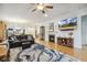 Open-concept living room with hardwood floors, a fireplace, and a view into other living spaces at 2410 Kinglass Dr, Fuquay Varina, NC 27526