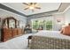Spacious main bedroom featuring tray ceiling, ceiling fan, ensuite bathroom, and walk-in closets for ultimate comfort at 2410 Kinglass Dr, Fuquay Varina, NC 27526