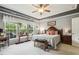 Comfortable main bedroom with a large window overlooking outdoor greenery, neutral decor, and ceiling fan at 2410 Kinglass Dr, Fuquay Varina, NC 27526