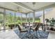 Enclosed sunroom with ample seating and views of the surrounding landscape at 2410 Kinglass Dr, Fuquay Varina, NC 27526