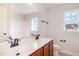 Inviting bathroom featuring double sinks, wood cabinets, and natural light at 2507 Belvinwood Dr, Fuquay Varina, NC 27526