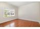 Bright bedroom features hardwood floors, a large window, and fresh paint at 2507 Belvinwood Dr, Fuquay Varina, NC 27526