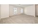 Bonus room featuring neutral carpet and two windows providing natural light at 2507 Belvinwood Dr, Fuquay Varina, NC 27526