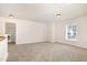 Open bonus room with neutral carpet and a doorway to the laundry room at 2507 Belvinwood Dr, Fuquay Varina, NC 27526