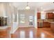 Bright dining area with hardwood floors, modern chandelier and an open kitchen at 2507 Belvinwood Dr, Fuquay Varina, NC 27526