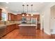 Stylish kitchen with stainless steel appliances, granite countertops, kitchen island and wooden cabinets at 2507 Belvinwood Dr, Fuquay Varina, NC 27526