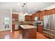 Well-equipped kitchen featuring stainless steel appliances, granite countertops, kitchen island and wooden cabinets at 2507 Belvinwood Dr, Fuquay Varina, NC 27526