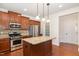 Modern kitchen with stainless steel appliances, granite countertops, a kitchen island, and ample storage at 2507 Belvinwood Dr, Fuquay Varina, NC 27526