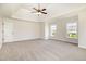 Spacious main bedroom with neutral carpet, tray ceiling, and many large windows at 2507 Belvinwood Dr, Fuquay Varina, NC 27526