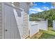 Backyard features a white wooden fence, green grass, and storage shed entry at 2513 Asher View Ct, Raleigh, NC 27606