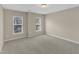 Bright bedroom with neutral walls, carpet, and natural light from two windows at 2513 Asher View Ct, Raleigh, NC 27606
