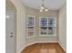 Bright dining area featuring hardwood floors and natural light from large windows at 2513 Asher View Ct, Raleigh, NC 27606