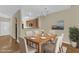 Open dining area with wood table, six chairs, and kitchen access at 2513 Asher View Ct, Raleigh, NC 27606