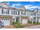 Attractive townhomes with stone accents, well-maintained landscaping, and private garages at 2513 Asher View Ct, Raleigh, NC 27606